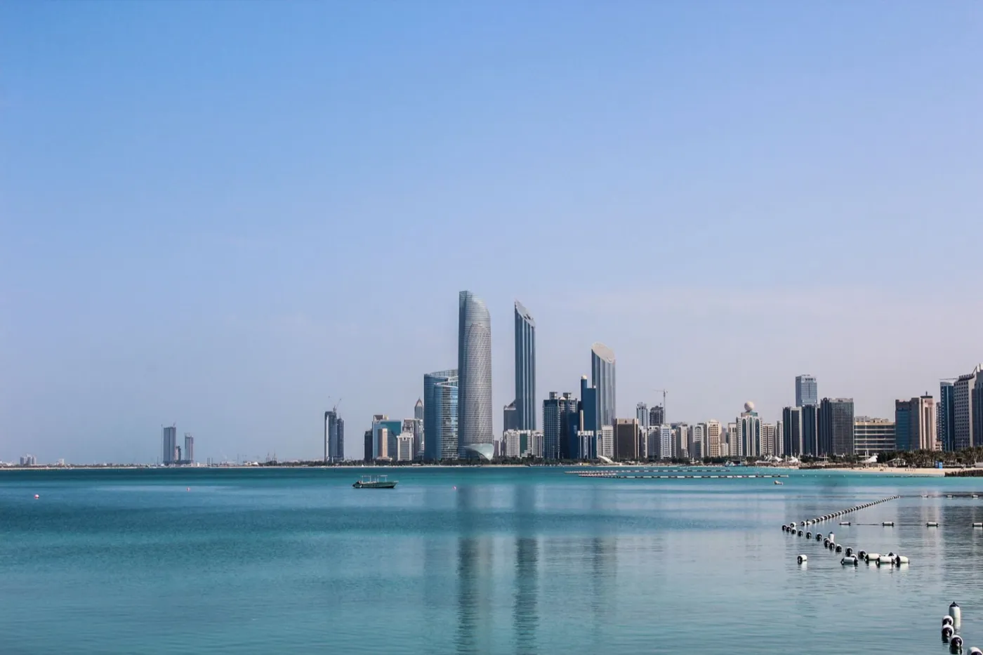 Abu Dhabi skyline reflected in calm water